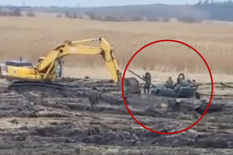 Russian troops digging out a tank during drills in Rostov region