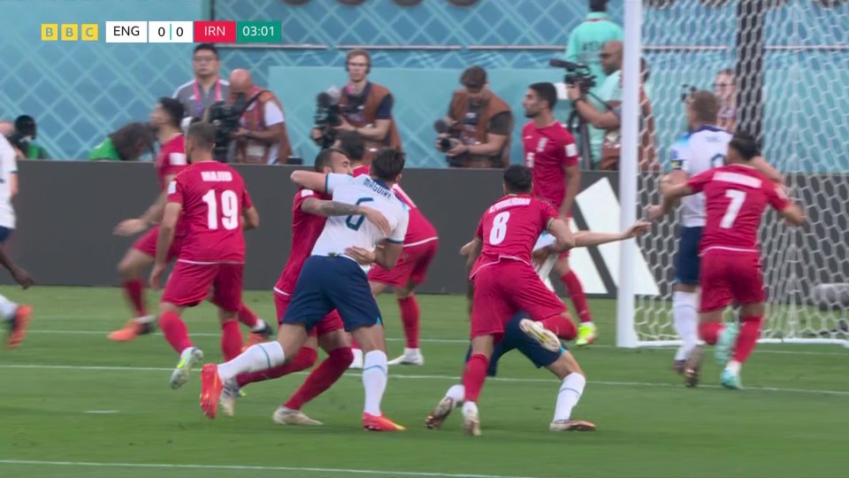 Harry Maguire tussles with his marker in the box