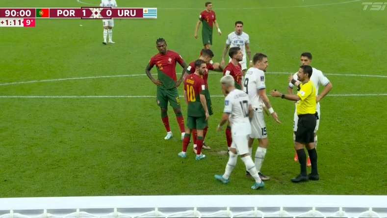 Portugal’s players gather round the penalty spot to protect it from Uruguay’s dirty tricks