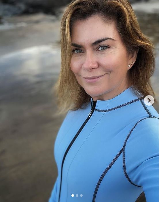 Amanda, 50, sports a blue skintight wetsuit before ice cold dip in Devon