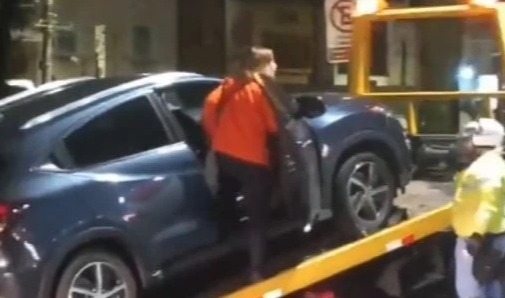 This woman climbed into her car to try and stop it from being towed away