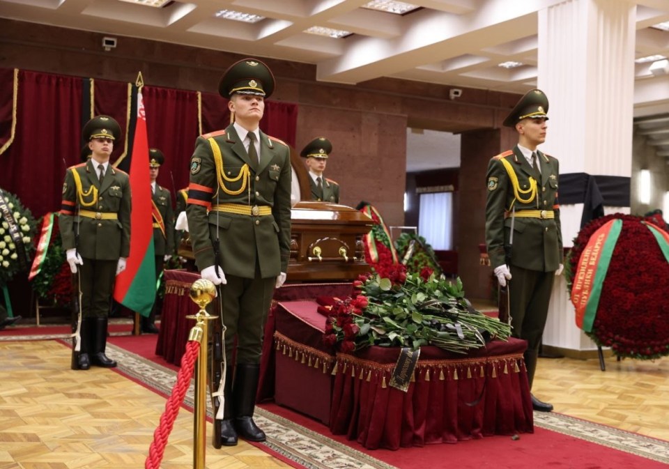 Guards stand beside Makei's coffin