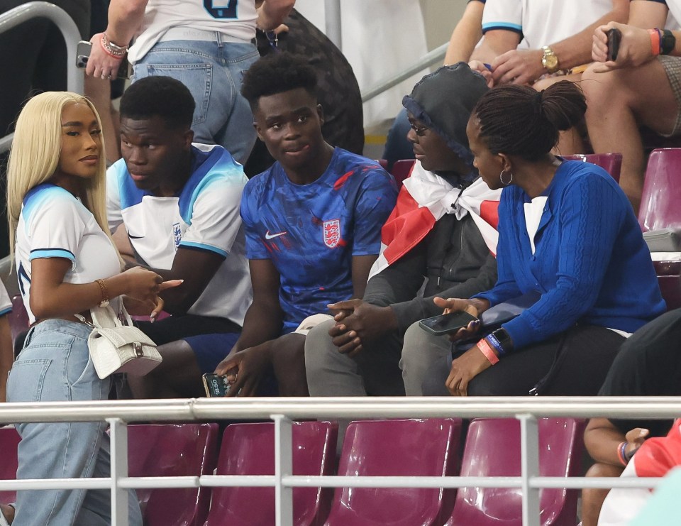 Bukayo Saka visits Wag Tolami Benson in the stands after the win over Iran