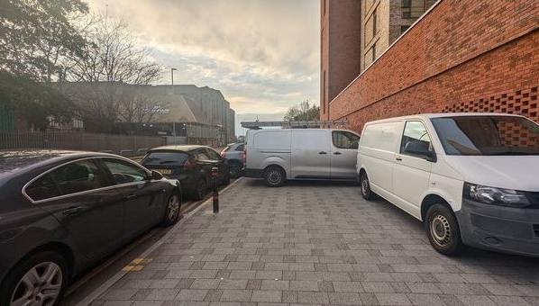 Pictures showed "at least 20 vehicles" on the pavement in Trafford Wharf Road, Manchester