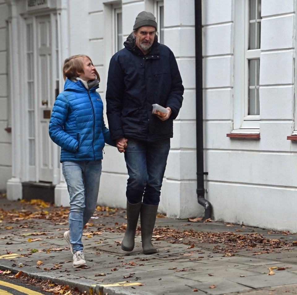 Roger Hallam, 56, and Frieda Luerken, 24, seen holding hands on a walk in South London