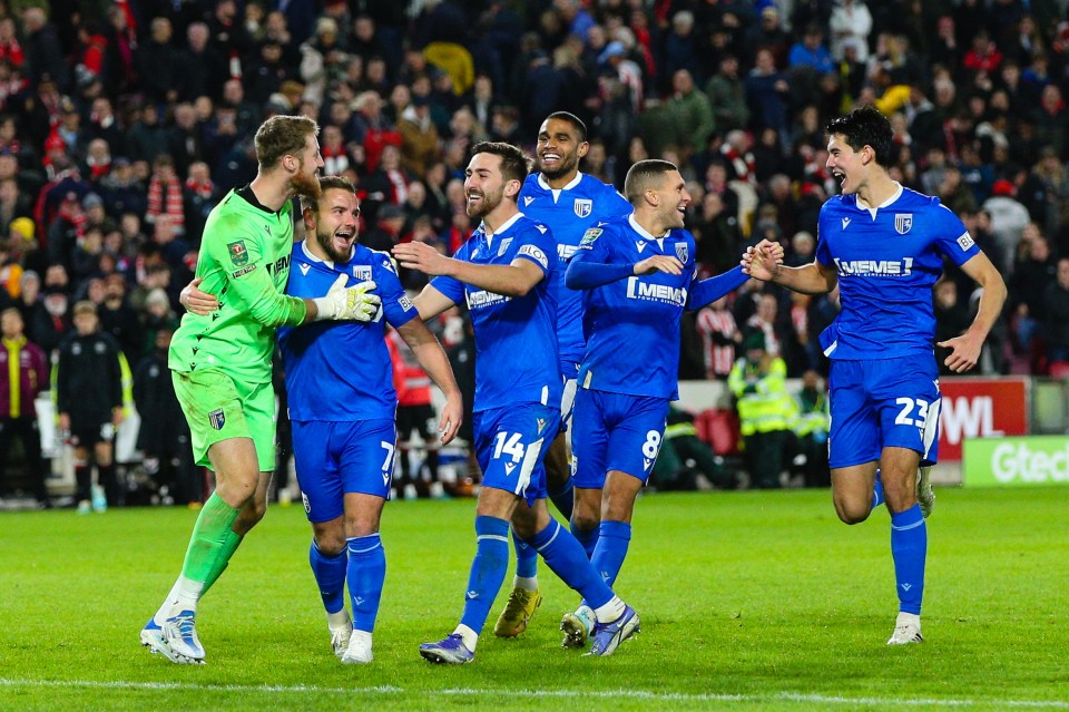 The Gillingham players celebrate after winning on penalties