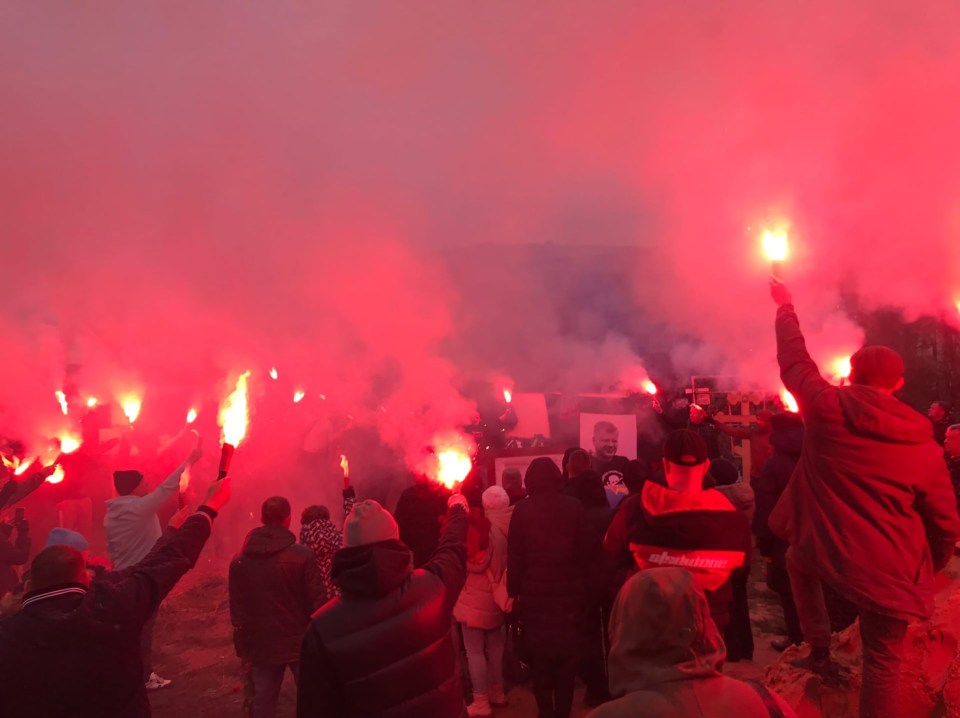 Supporters of the ultra hooligan lit red flares at his funeral