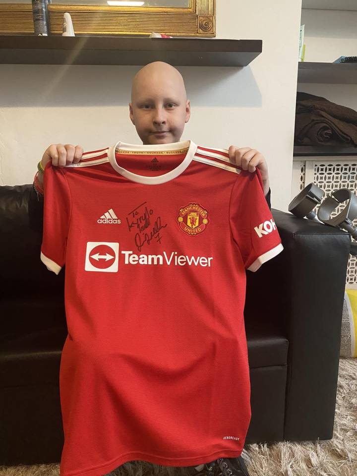 Red Devils fan Kyrylo, 12, who suffers from sarcoma, shows off his souvenir