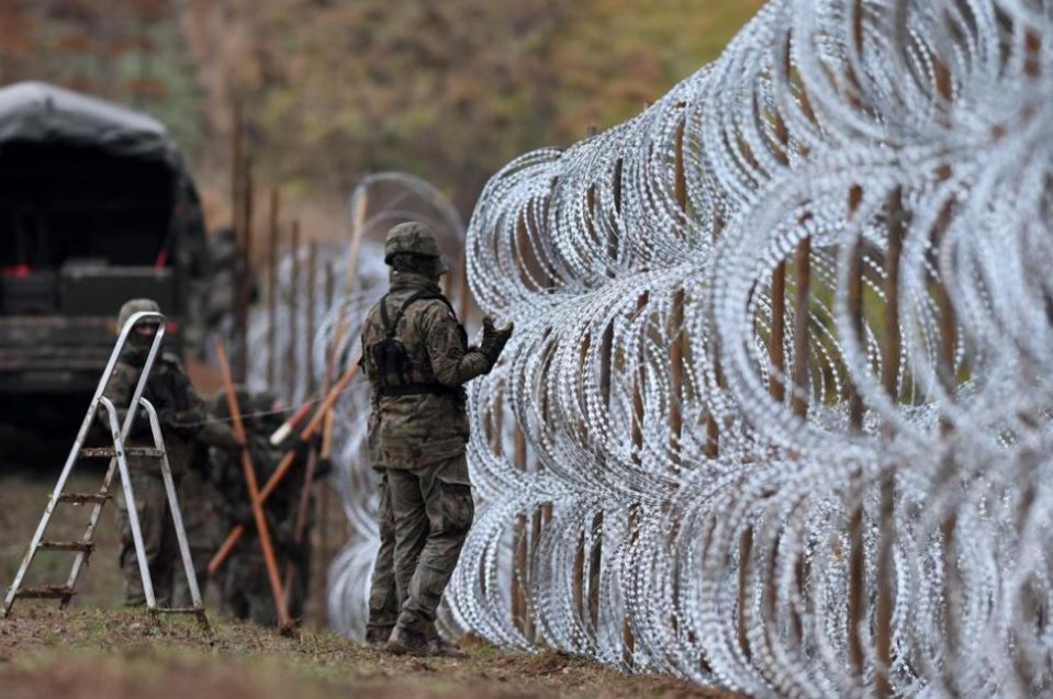 Polish soldiers lay 8ft-high razor wire fences on the border with Kaliningrad this week