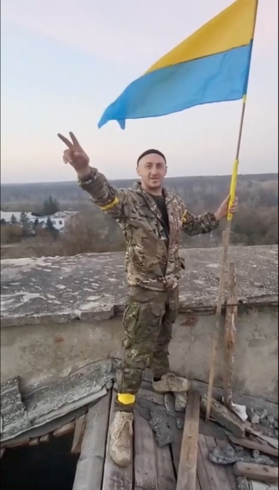 A soldier with a Ukrainian flag in Kalynivske in Kherson region