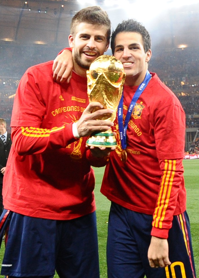 Pique celebrates winning the 2010 World Cup alongside Cesc Fabregas