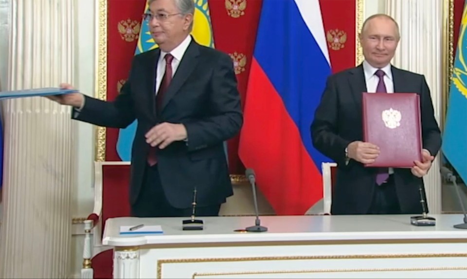 Putin and Tokayev exchanged documents with a brief handshake and eye contact - but only for a split second