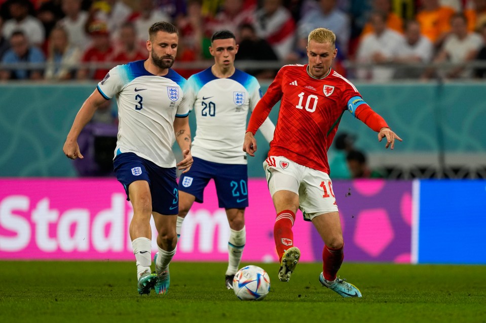 Aaron Ramsey (Wales) vies for the ball against England players during a World Cup match.