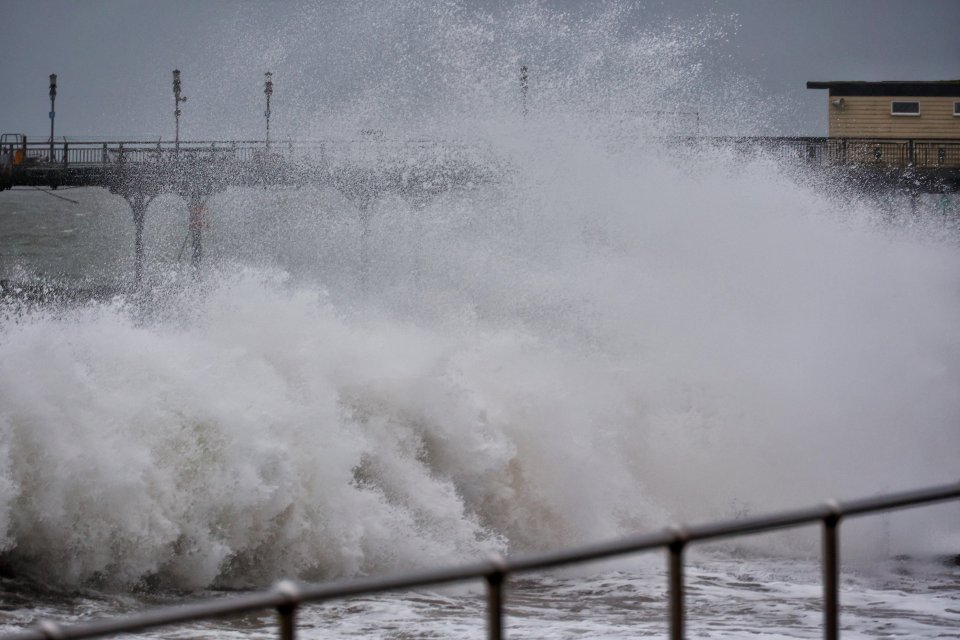 Waves lash at the pier in Teignmouth today