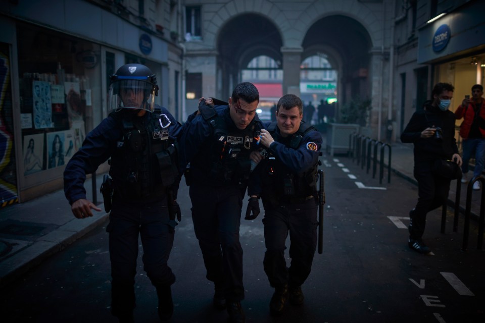 Another hurt cop being helped by colleagues