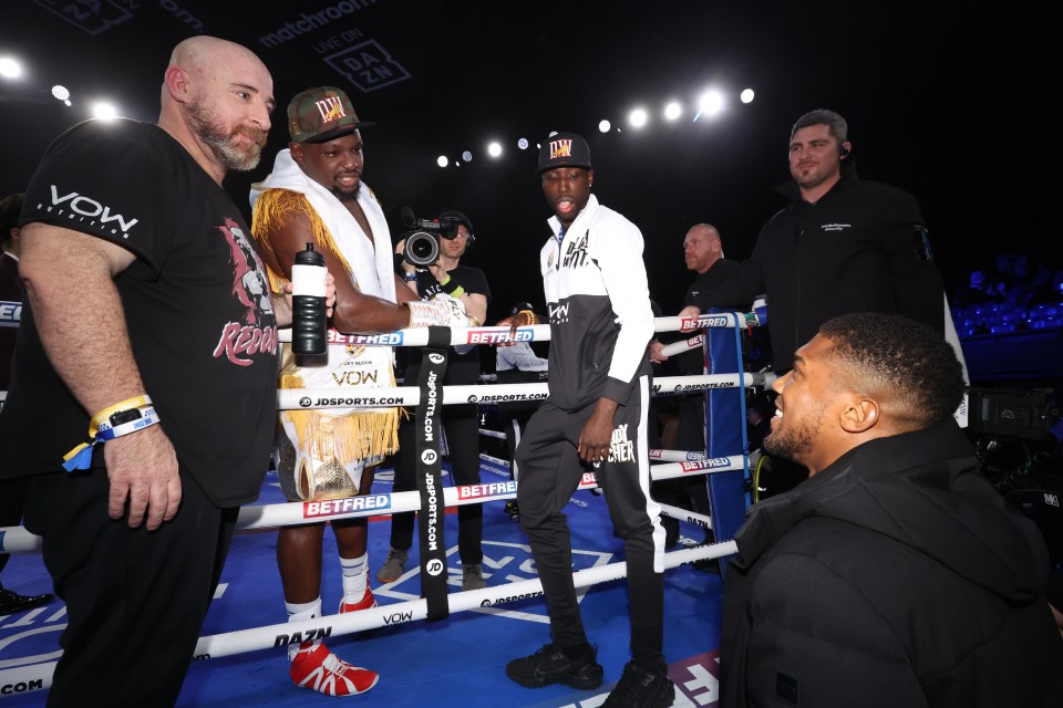 Dillian Whyte embracing with Anthony Joshua