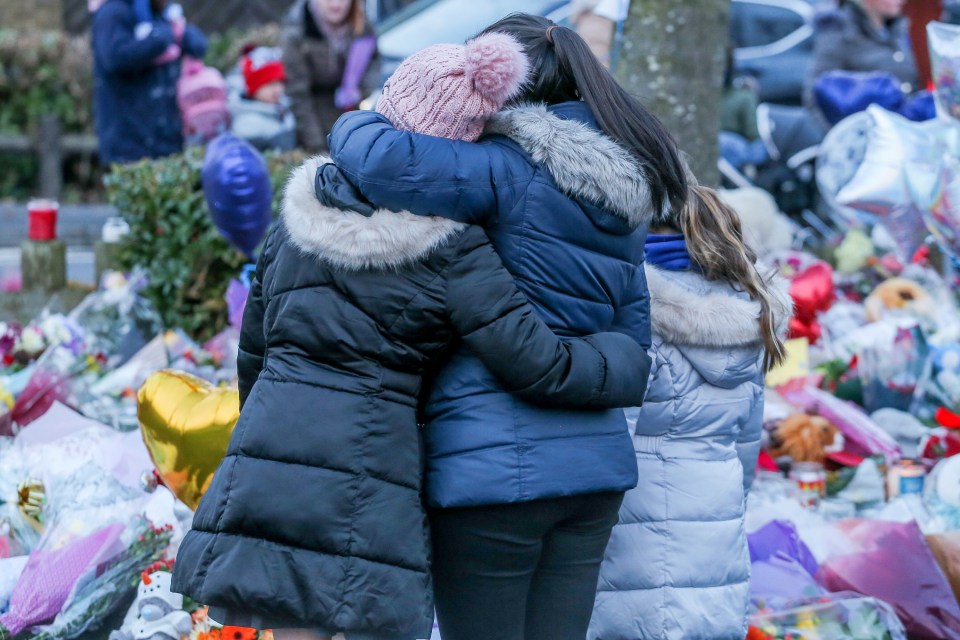 People gathered around the tributes today