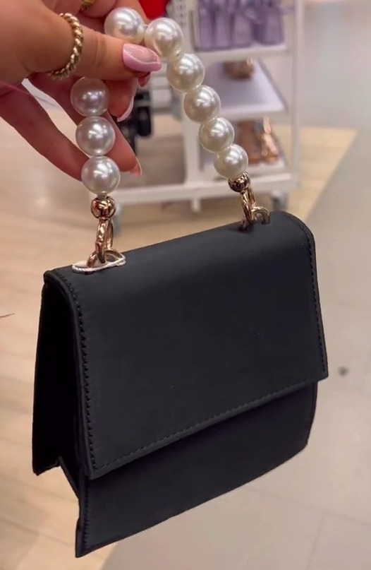 She also picked up this mini satin handbag with a pearl-beaded handle