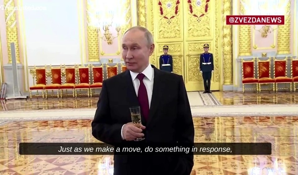 Putin appeared clasping a glass of champagne at an awards ceremony