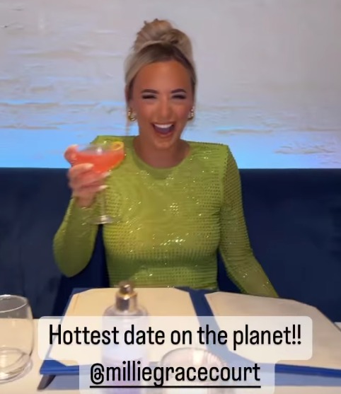 Millie raised a cocktail in a Greek restaurant