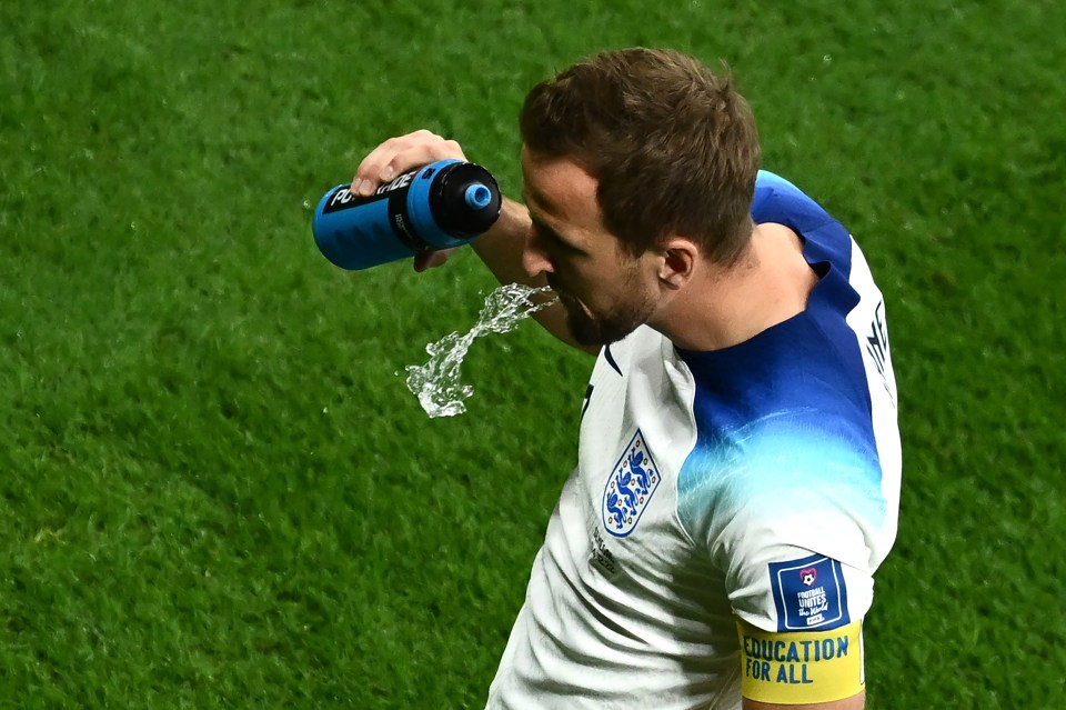 Harry Kane spits water out after drinking