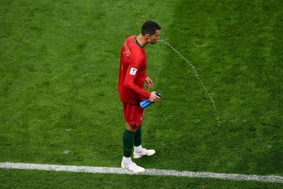 Cristiano Ronaldo spits out his water on the touchline