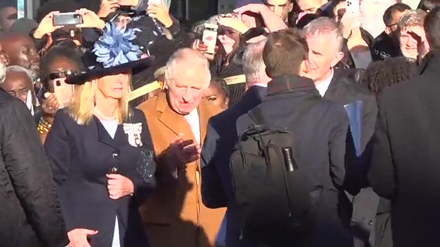 Charles is led away by members of his security after the alleged incident