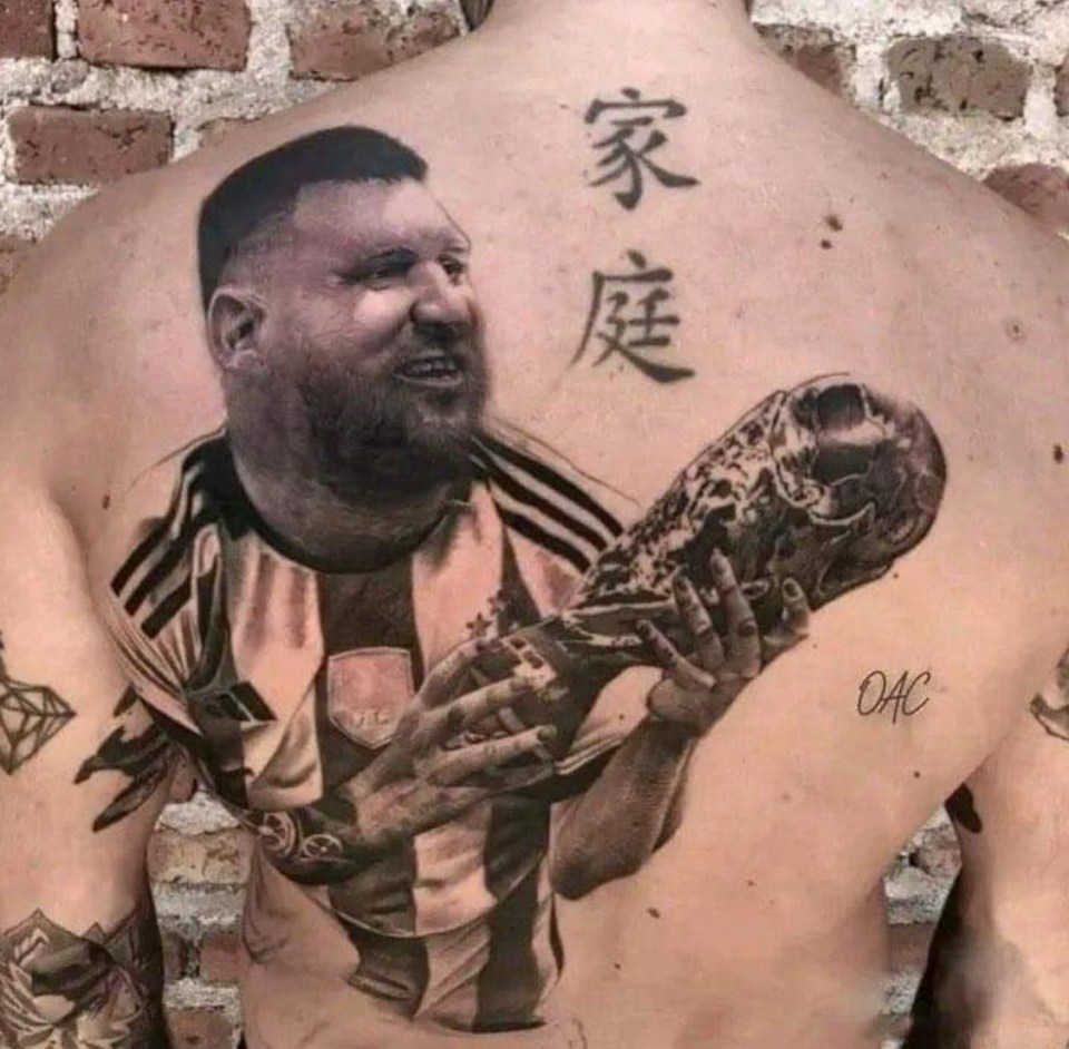 A fan appears to have a had Lionel Messi holding the World Cup inked on his back