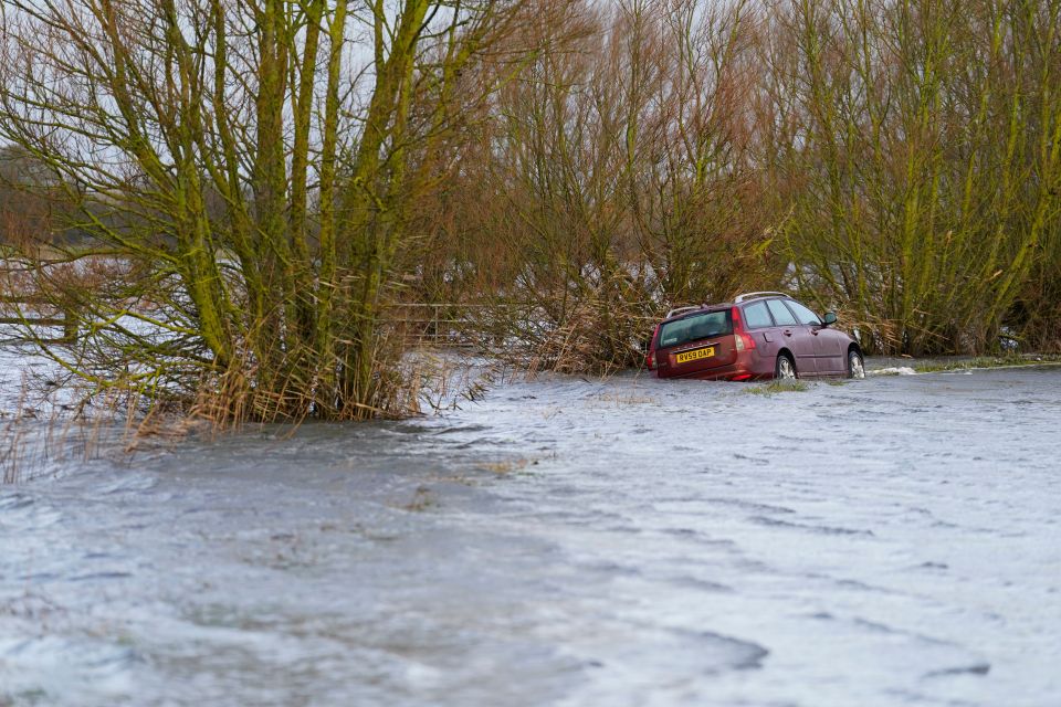 An abandoned car in flood water near to the village of Muchelney in Somerset