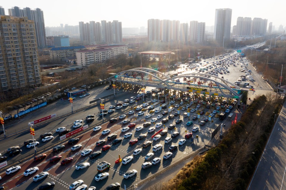 Hundreds of cars queuing up to pass a toll station on the last day of Spring Festival holiday in 2021