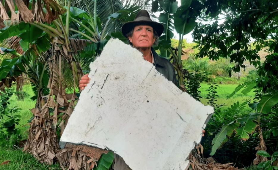 Blaine Gibson, an American debris hunter, holding the crucial piece of wreckage