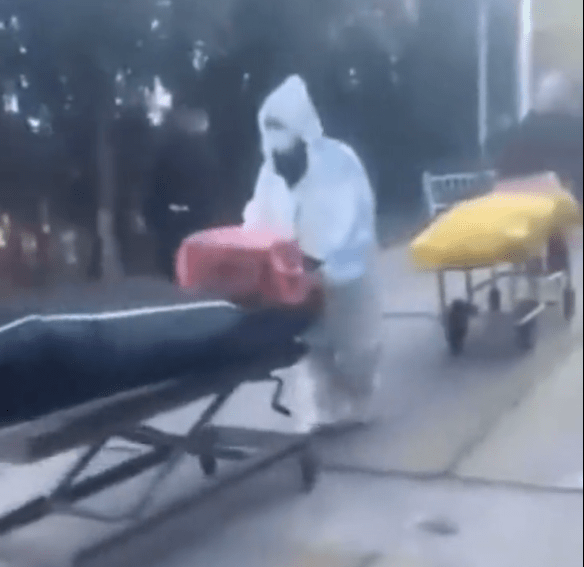 Body bags being wheeled into a crematorium in China