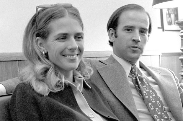 a man and a woman are sitting next to each other and smiling