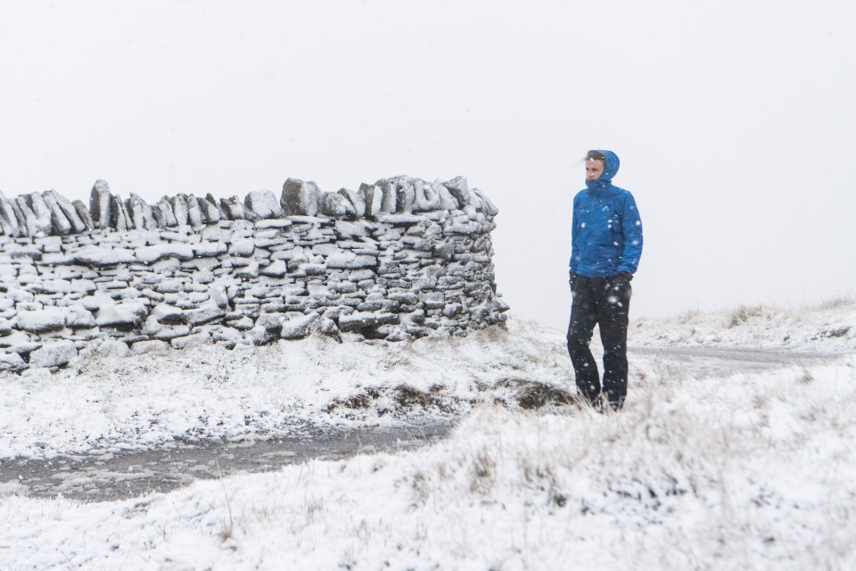 A man braves walking through the winter snow in Cumbria