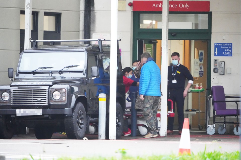 Today families have been forced to rush their loved ones to hospital in their own cars. Above a nurse is seen trying to get a patient out of the car before taking them into hospital at the Royal Sussex County Hospital in Brighton