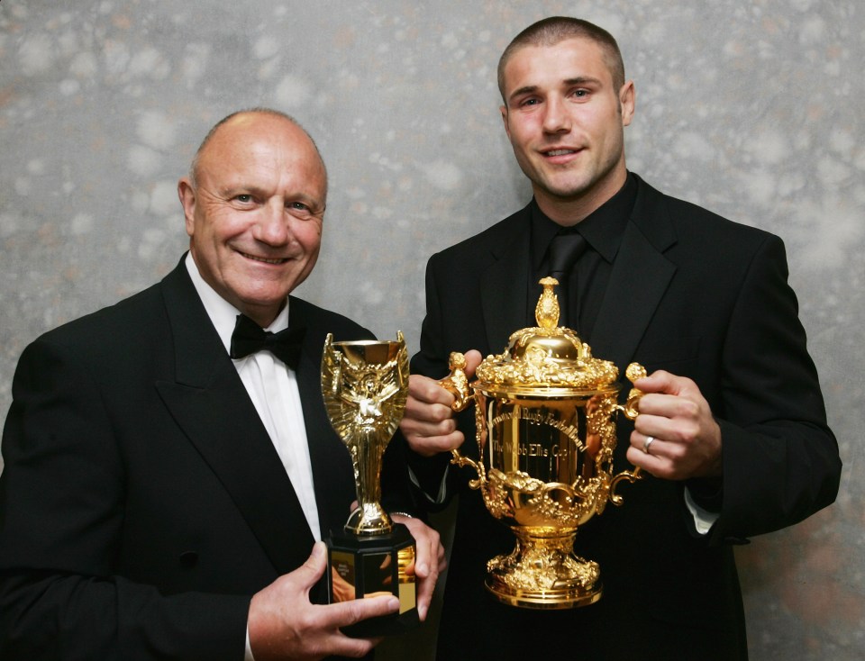 George Cohen and his nephew Ben pose together with the football and rugby World Cups – which they both won