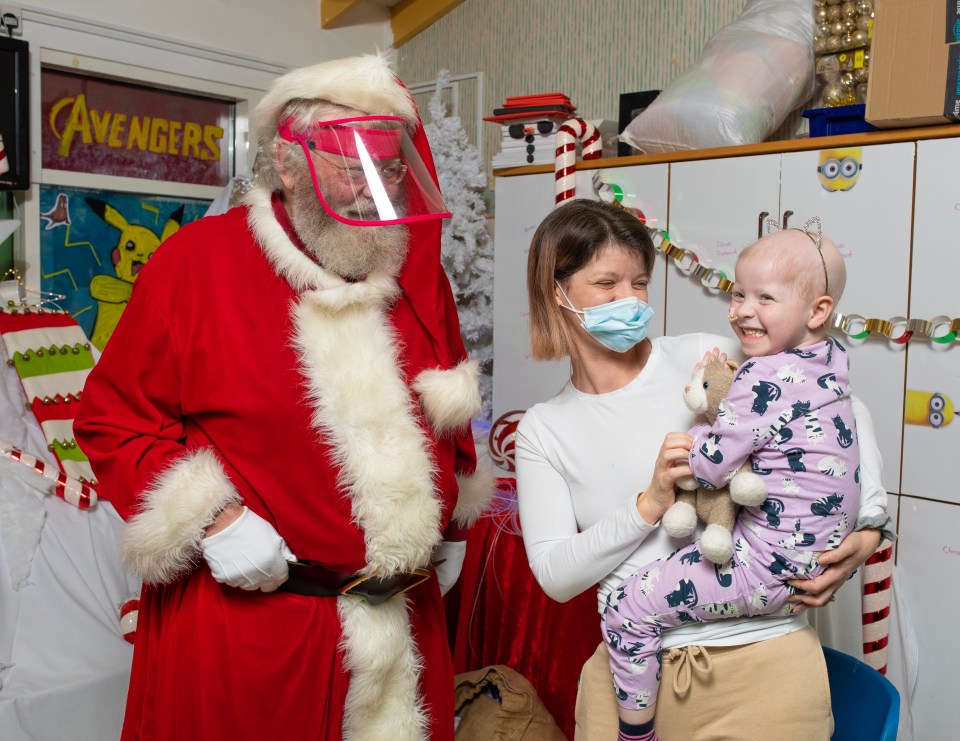 Claire Tibbs and daughter Niamh, three, meet visor-wearing Santa in Bristol