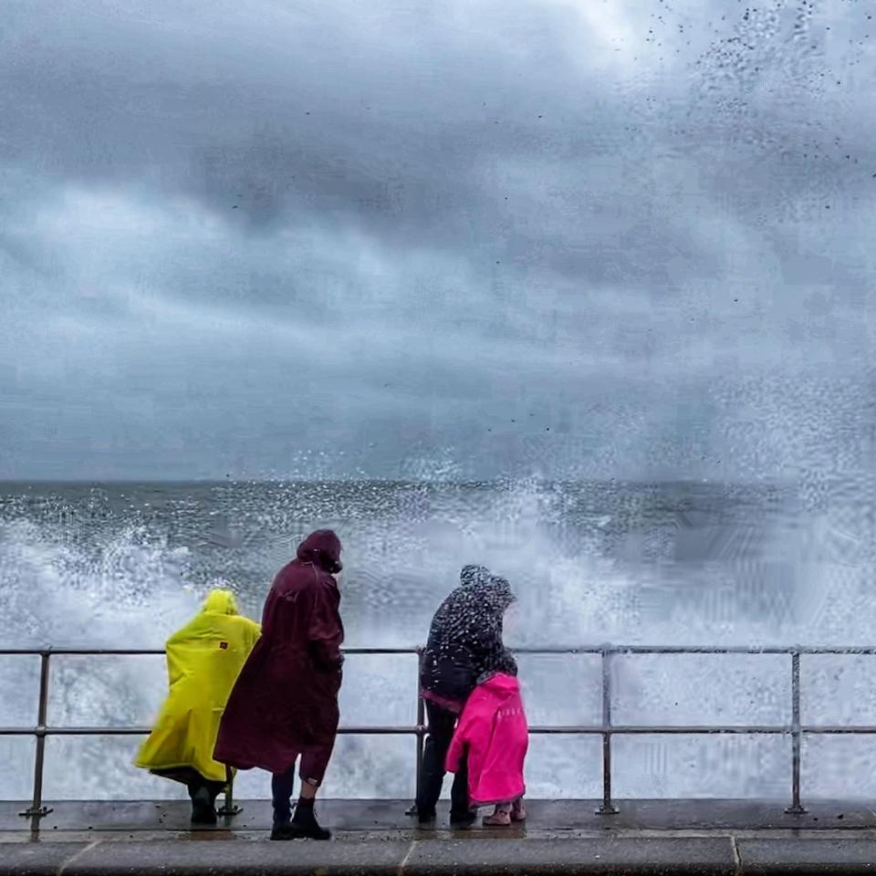 People watch the waves in Teignmouth today