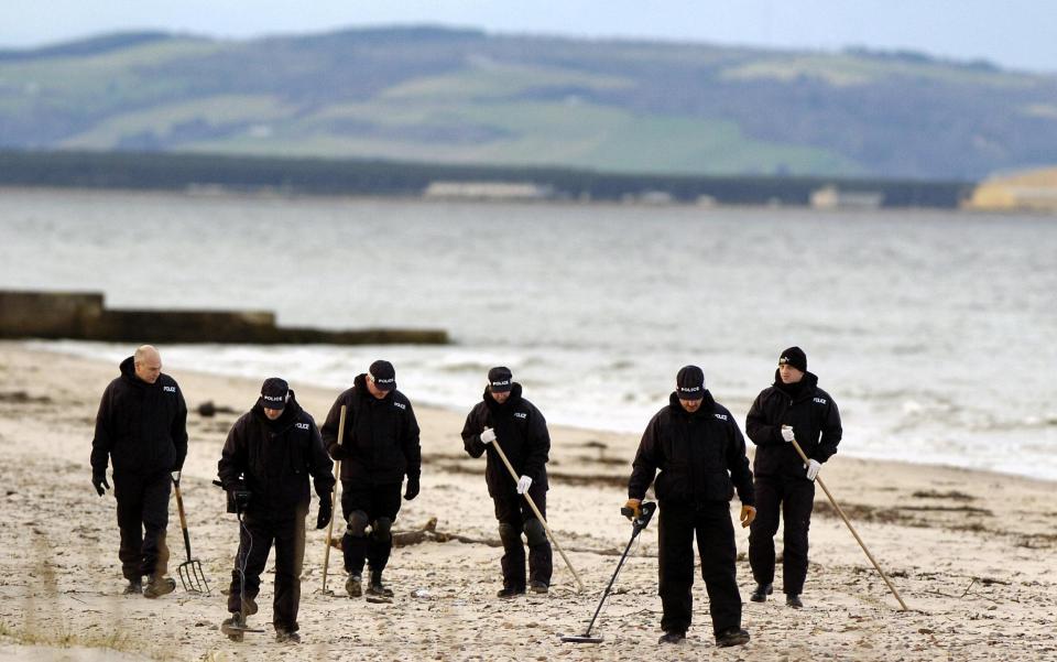 Police search a nearby beach for clothes