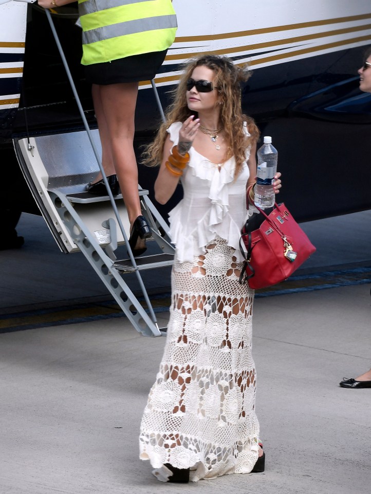 Rita was seen arriving in the Caribbean in a white ruffled number