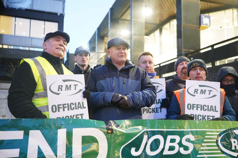 Mick Lynch (centre) general secretary of the Rail, Maritime and Transport union (RMT) joins members on the picket line outside London Euston train station during a strike earlier this month