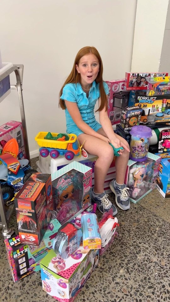 Girl surrounded by toys.