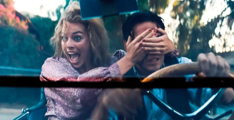 Margot covers a driver’s eyes in the new flick