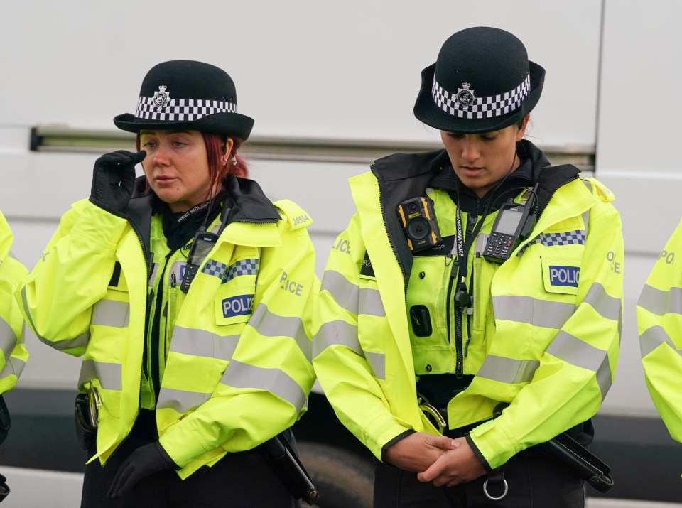 A police officer wipes a tear away following the tragedy