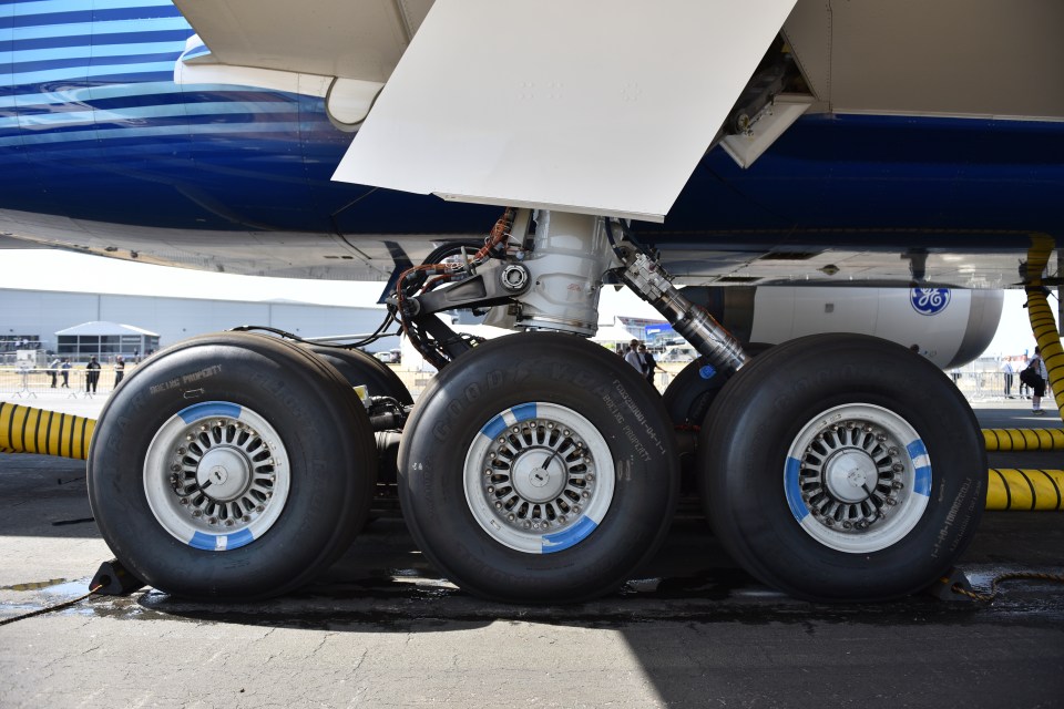 The landing gear of a Boeing 777, showing the trunnion door