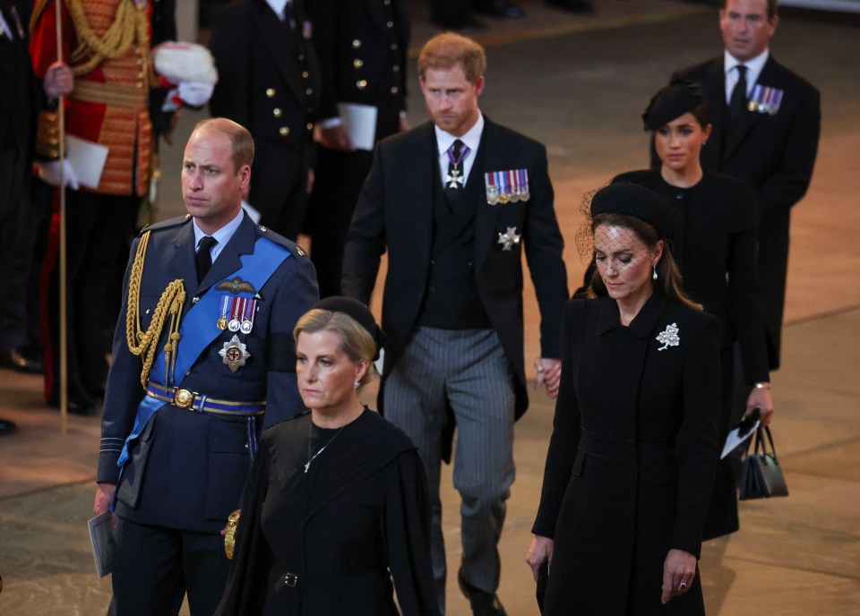 The couples look tense as they follow the Queen's coffin as it is moved to Westminster Abbey for the monarch to lie in state