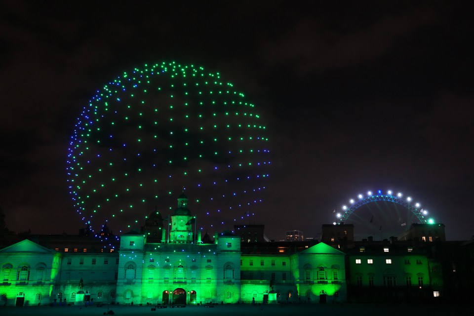 A drone show is seen over the London skyline