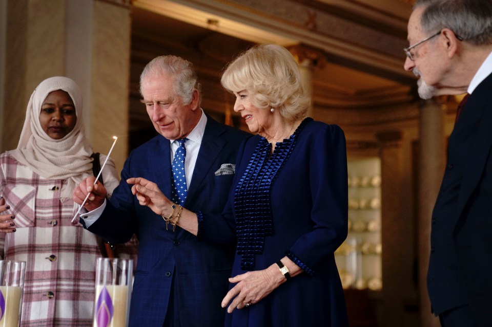 King Charles and Queen Camilla light two candles at Buckingham Palace to mark Holocaust Memorial Day