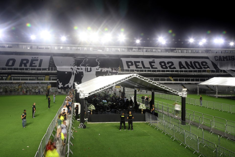 Mourners pay respect to Pele's coffin on the Santos pitch