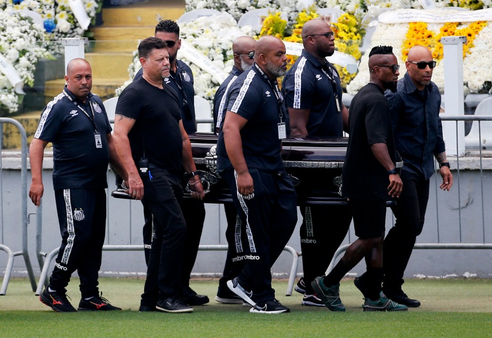 Pallbearers carry the casket of Brazilian soccer legend Pele